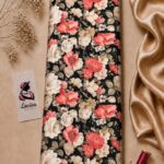 Elegant floral print on a black background with soft ivory and coral blooms-Italian Silk (ST01)