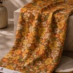 Vintage floral design with warm autumn blooms on a rich amber background- Italian Chiffon Zari (ZR16)