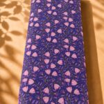 Delicate pink floral pattern on a deep purple background with an elegant botanical design-Spanish Cotton (PC11)