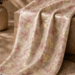 Ivory chiffon zari fabric featuring delicate pink bow motifs with shimmering gold accents for a soft, elegant look-Italian Chiffon Zari (ZR16)