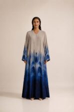 Elegant beige abaya featuring a deep blue gradient print, creating a sophisticated and modern look