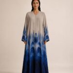 Elegant beige abaya featuring a deep blue gradient print, creating a sophisticated and modern look