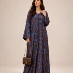 Flowing brown abaya adorned with rich blue floral prints, creating an elegant and graceful look