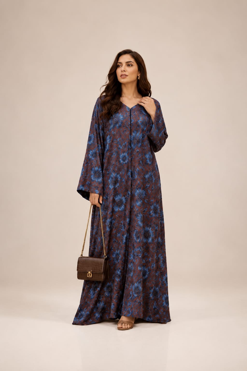 2026/08/1000054565.jpg Flowing brown abaya adorned with rich blue floral prints, creating an elegant and graceful look - الصورة 1