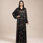Black abaya featuring elegant chain and equestrian-inspired motifs in rich brown and gold tones, adding a luxurious and distinctive touch