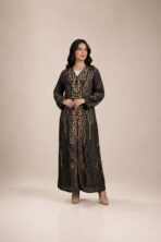 Black abaya featuring an abstract dotted pattern in warm beige tones, arranged in elegant vertical detailing.