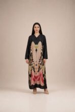 Statement abaya featuring a bold symmetrical floral-inspired print in soft beige, blush pink, red, and olive tones.
