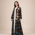 Open-front abaya featuring bold geometric and abstract motifs in teal, beige, mustard, and deep brown tones