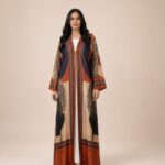 Open-front abaya featuring artistic abstract motifs and intricate geometric borders in warm rust, beige, and deep navy tones