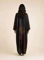 Flowing abaya adorned with vibrant abstract motifs in orange, red, and green tones, concentrated along the sleeves and lower part. - Image 2