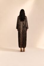 Black abaya featuring an abstract dotted pattern in warm beige tones, arranged in elegant vertical detailing. - Image 2