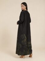 ⁦Elegant abaya featuring subtle botanical leaf motifs in deep olive and gold tones, beautifully concentrated along the lower hem.⁩ - الصورة ⁦2⁩