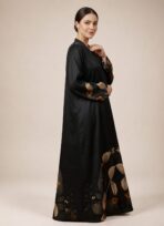 Black abaya featuring graceful floral detailing in warm beige and burnt orange tones, beautifully placed along the hem and sleeves. - Image 3