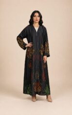 Flowing abaya adorned with vibrant abstract motifs in orange, red, and green tones, concentrated along the sleeves and lower part. - Image 3