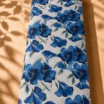 Striking blue florals with soft green leaves on a light ivory background (CR01)