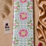 Decorative floral pattern featuring pink blossoms, soft green leaves, and elegant turquoise swirls on a clean ivory background - Silk Jacquard (JD02)