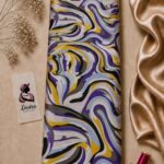 Dynamic abstract wave design in purple, mustard yellow, black, grey, and soft blue tones on a light neutral background - Silk Jacquard (JD02)
