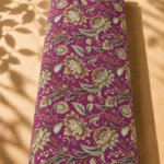 Luxurious botanical print featuring ornate golden and brown florals with elegant leafy details on a rich magenta background.