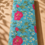 Fresh floral design featuring bold fuchsia blossoms, delicate white flowers, and leafy branches on a vibrant turquoise-blue background - SWISS COTTON (PC01)