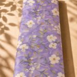 Soft botanical design featuring delicate ivory flowers and graceful leafy branches on a dreamy lavender background - SWISS COTTON (PC01)