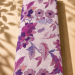 Artistic floral pattern with bold blossoms and graceful botanical details in rich berry, plum, and dusty rose tones over a soft cream base - SWISS COTTON (PC01)