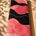 Modern abstract wave design in coral pink and black with playful dotted accents - Spanish Cotton (PC11)
