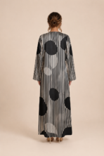 Striking black and white abaya featuring fine vertical stripes with bold oversized polka dots for a modern geometric look - Image 2