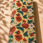 Warm yellow chiffon with rich red florals, soft white blossoms, and deep green leaves - Italian Chiffon (CF01)