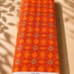 Vibrant orange chiffon with repeating red geometric motifs and delicate cream floral accents - Italian Chiffon (CF01)