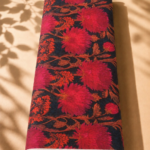 Deep navy chiffon adorned with bold crimson and fuchsia florals accented by warm rust-toned branches - Italian Chiffon (CF01)