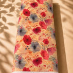 Warm beige chiffon with vivid red, coral, and smoky blue watercolor florals accented by delicate botanical branches - Italian Chiffon (CF01)