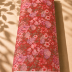 Rich coral red chiffon adorned with delicate pink and lavender blossoms and subtle leafy details - Italian Chiffon (CF01)