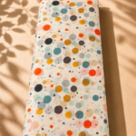 Ivory chiffon with playful multicolored dots in orange, teal, mustard, gray, and soft pastel tones - Italian Chiffon (CF01)