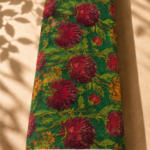 Emerald green chiffon with rich burgundy florals, warm golden accents, and elegant leafy branches - Italian Chiffon (CF01)