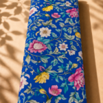 Royal blue cotton with elegant pink, white, and yellow florals intertwined with soft green leafy vines - Italian Cotton (PC02)