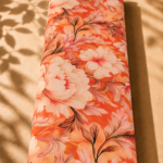Vibrant coral-orange cotton with large ivory florals and elegant flowing leaves in soft pink and brown tones - Italian Cotton (PC02)