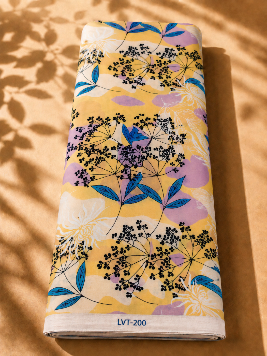 2026/08/1000058902-2.png Soft yellow cotton with delicate black botanical florals, vibrant blue leaves, and subtle lavender accents - Italian Cotton (PC02) - الصورة 1