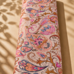 Soft beige cotton featuring elegant paisley motifs and ornamental floral swirls in pink, peach, blue, and warm brown tones - Italian Cotton (PC02)