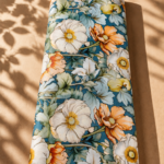 Teal blue cotton with large ivory and soft orange flowers, accented by layered sage-green foliage - Italian Cotton (PC02)