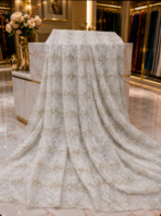 ⁦Ivory French embroidered lace, gracefully detailed with refined floral motifs and sparkling crystal accents for an exquisite finish.⁩ - الصورة ⁦2⁩