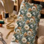 Vintage botanical florals in soft ivory and peach tones on a muted blue background