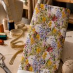 Vibrant botanical florals in yellow, white, blue, and red with fresh green foliage.