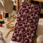 Luxurious pearl chains and jeweled bows on a rich burgundy background.