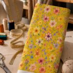 Cheerful multicolor florals on a vibrant golden-yellow background.