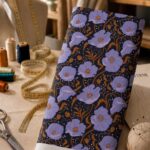 Elegant lavender blossoms intertwined with warm bronze vines and delicate accents on a deep navy background.