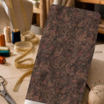 Intricate vintage paisley pattern in deep brown, black, and muted rose tones, creating a rich and elegant classic look.