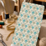 Elegant repeating arch pattern in turquoise, cream, and beige, accented with delicate floral details for a refined ornamental look.