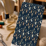 Celestial-inspired print with crescent moons, stars, and hanging lanterns on a deep navy background
