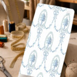Elegant blue floral medallions with delicate bows and ornamental garlands on a clean white background.