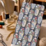 Elegant porcelain vase print with colorful floral bouquets on a deep navy background.